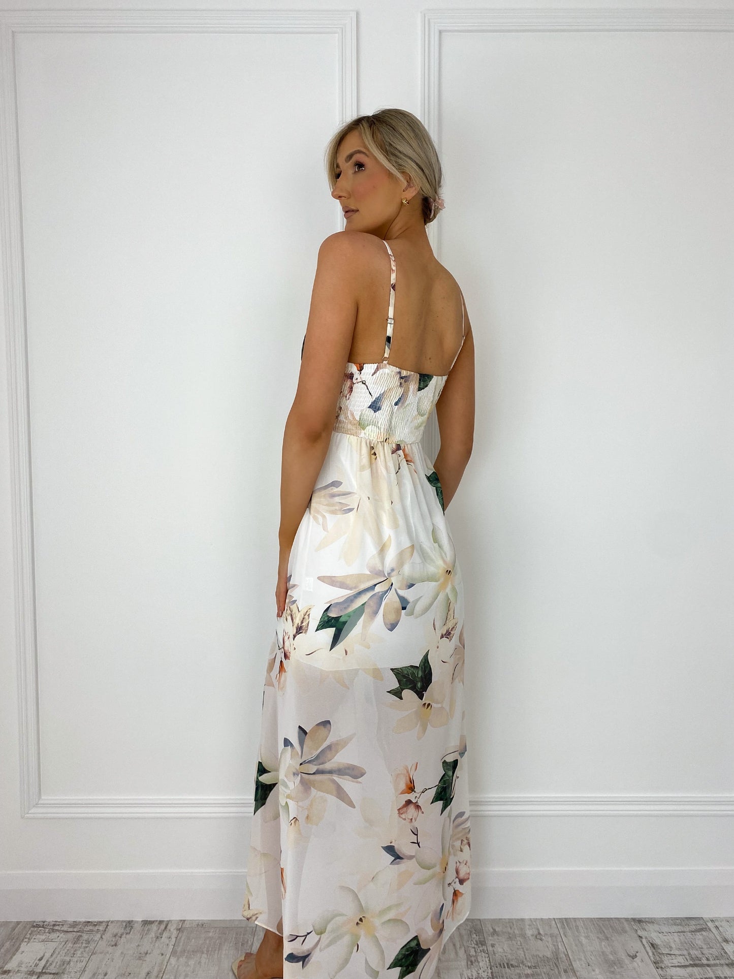 a woman in a white dress standing in a room