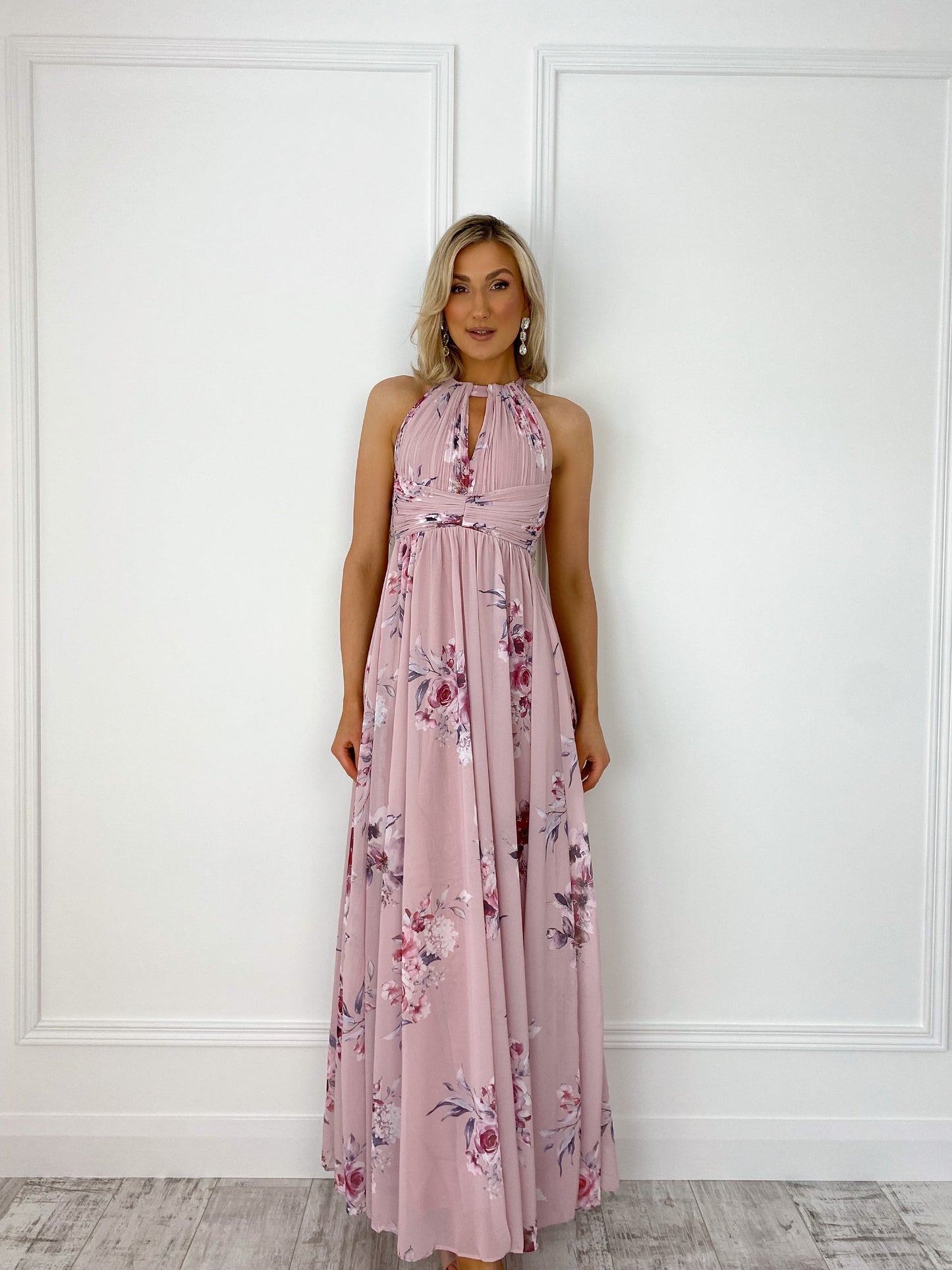 a woman in a pink dress holding a pink umbrella