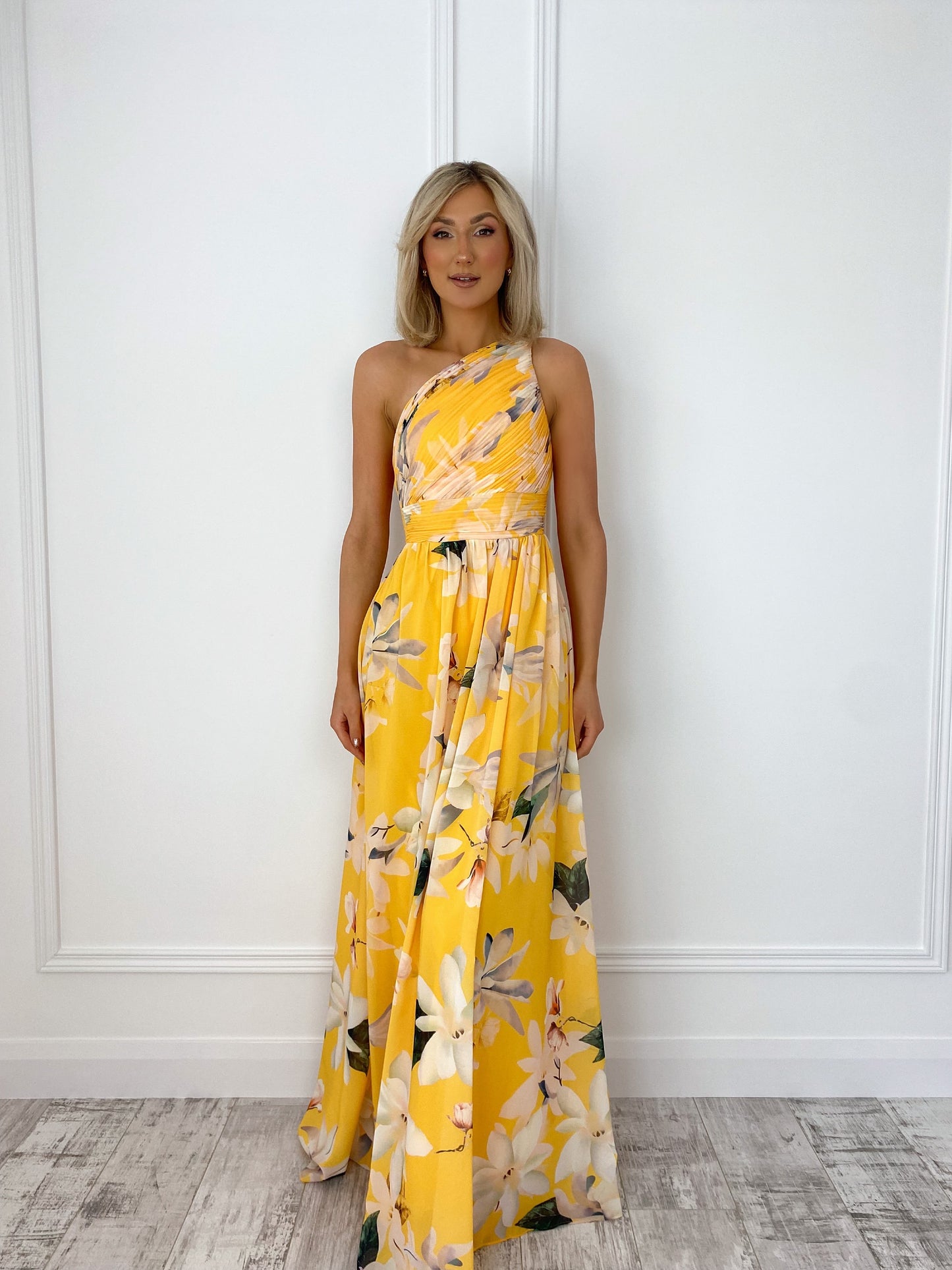 a woman in a yellow dress standing in front of a door 