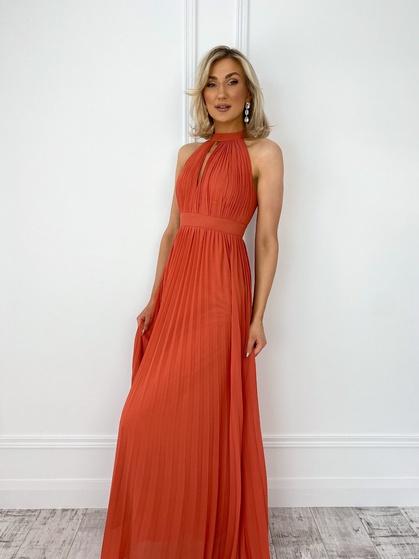 a woman in a red dress standing on a beach
