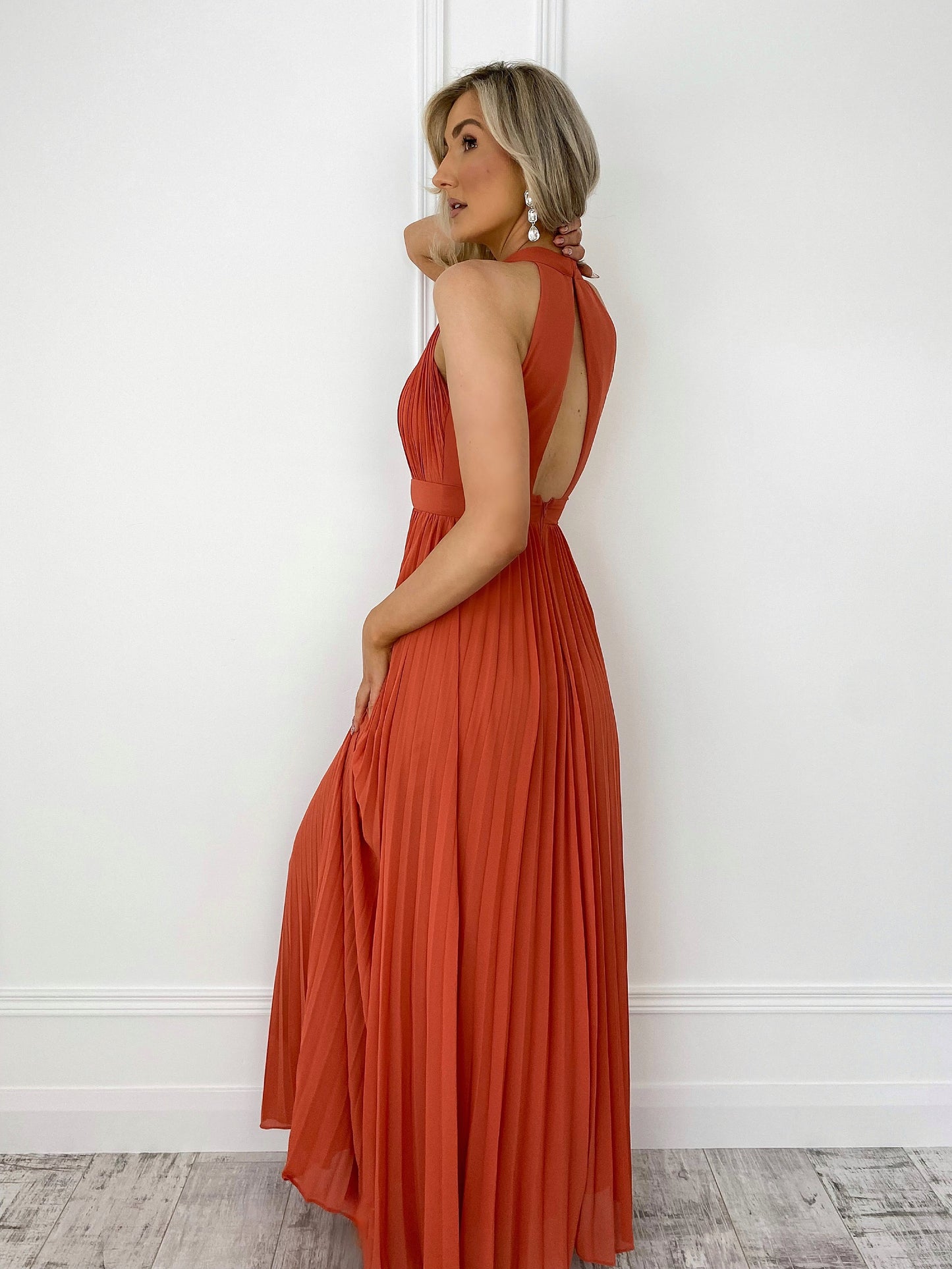 a woman in a red dress on a cell phone