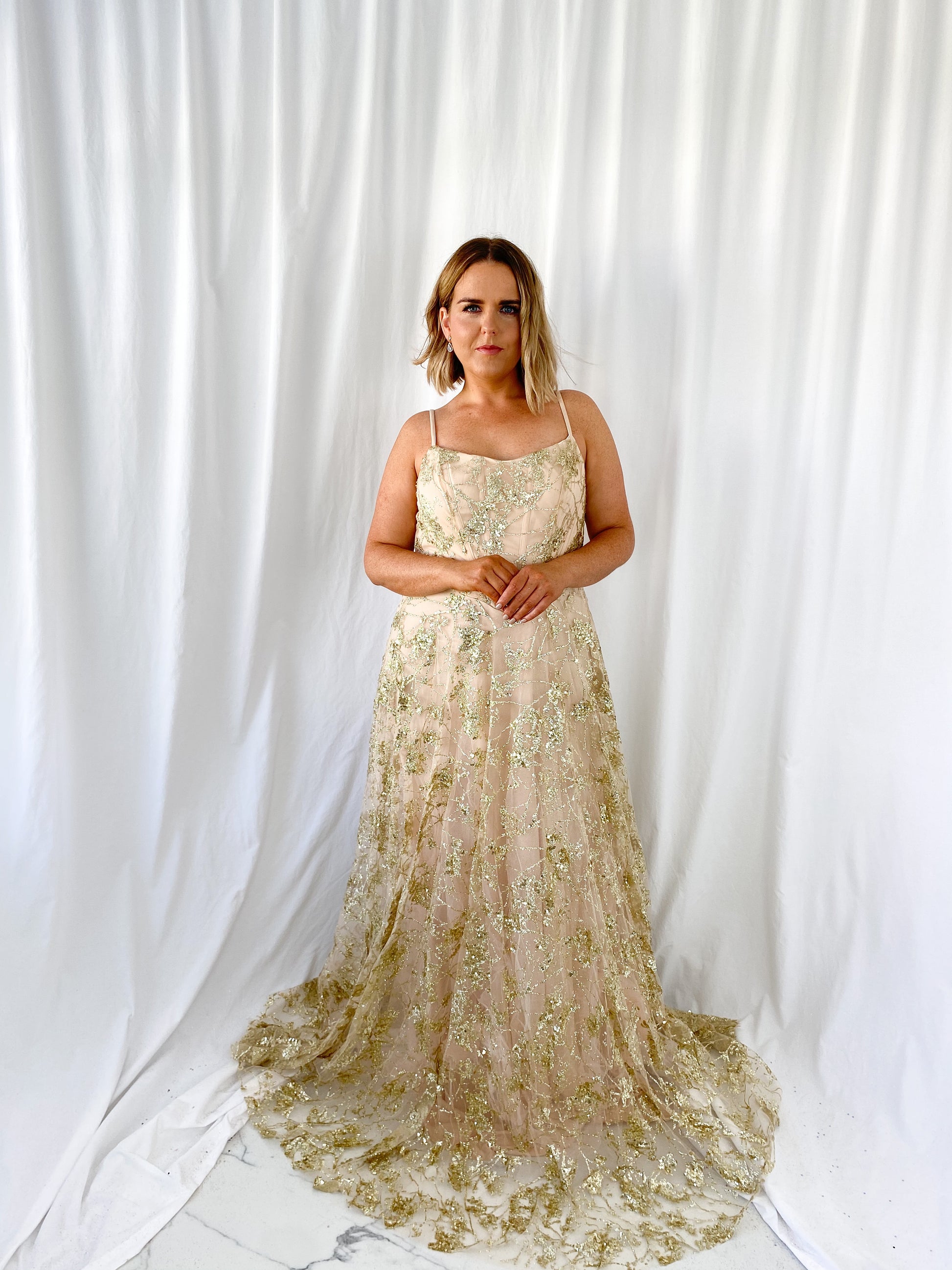 a woman in a white dress standing in a white dress 