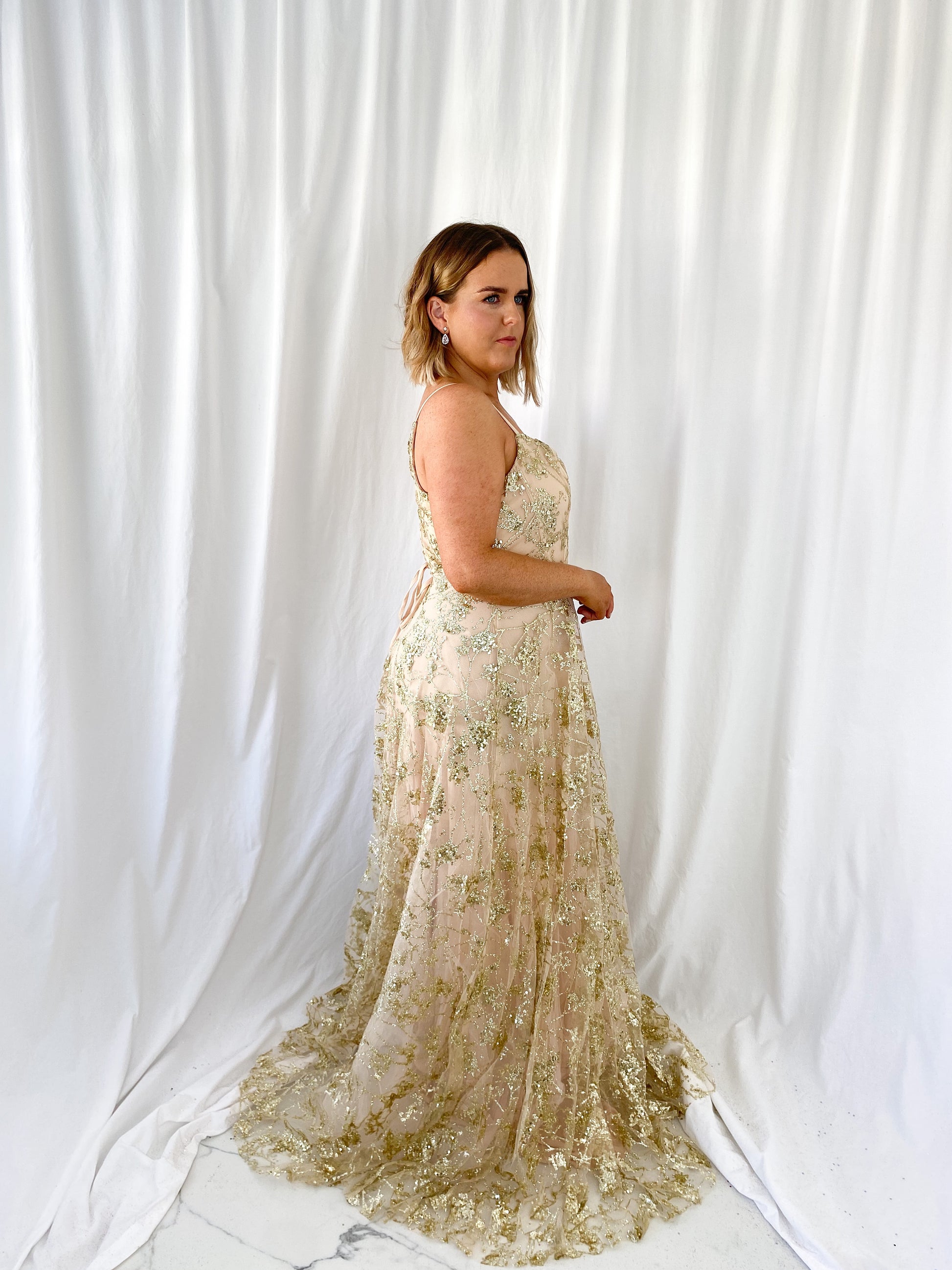 a woman in a white dress standing in a white dress 